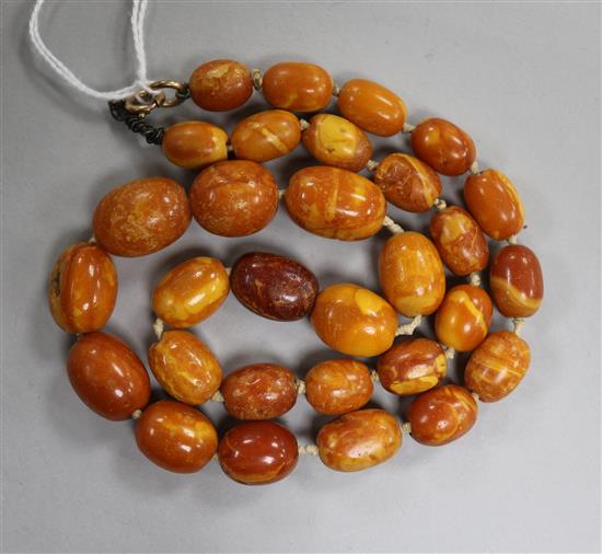 A single strand graduated oval amber bead necklace, with loose beads, gross weight 38 grams, 48cm.